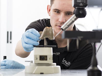 Invibio employee watching a PEEK knee inspection