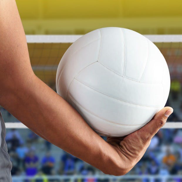 Volleyball player holding a white ball